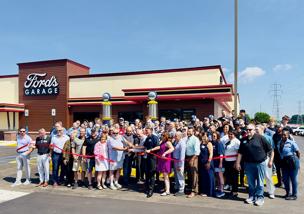 ribbon cutting outside of Ford's Garage Utica
